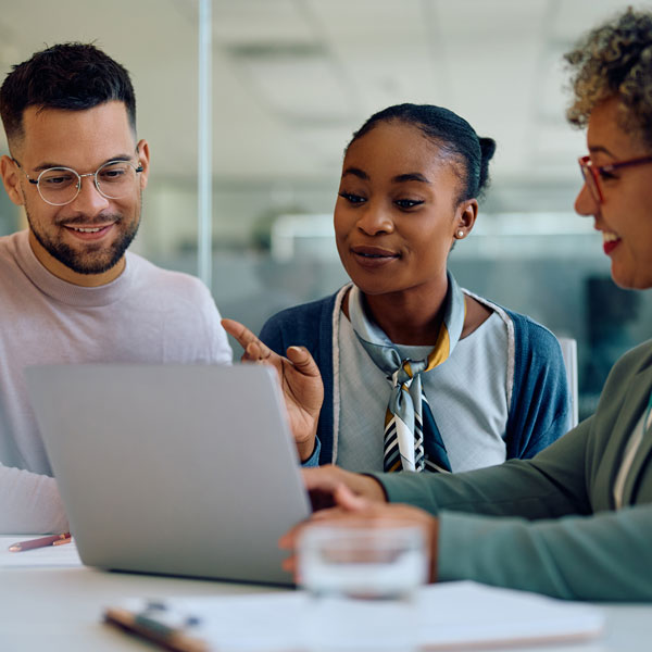 couple speaking with loan officer while looking at a tablet