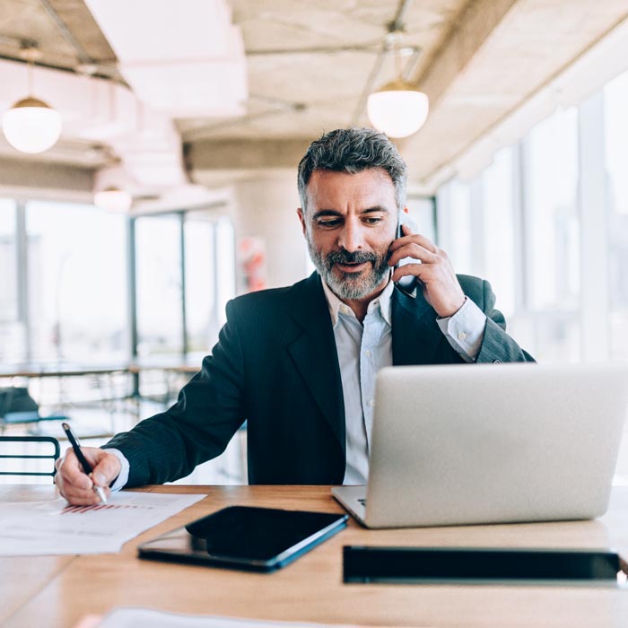 Businessman at the office talking on cell phone